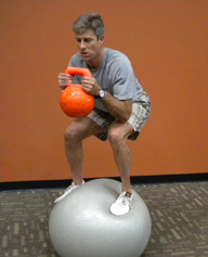 Lionel Martin doing a 55 lb. balance ball squat.